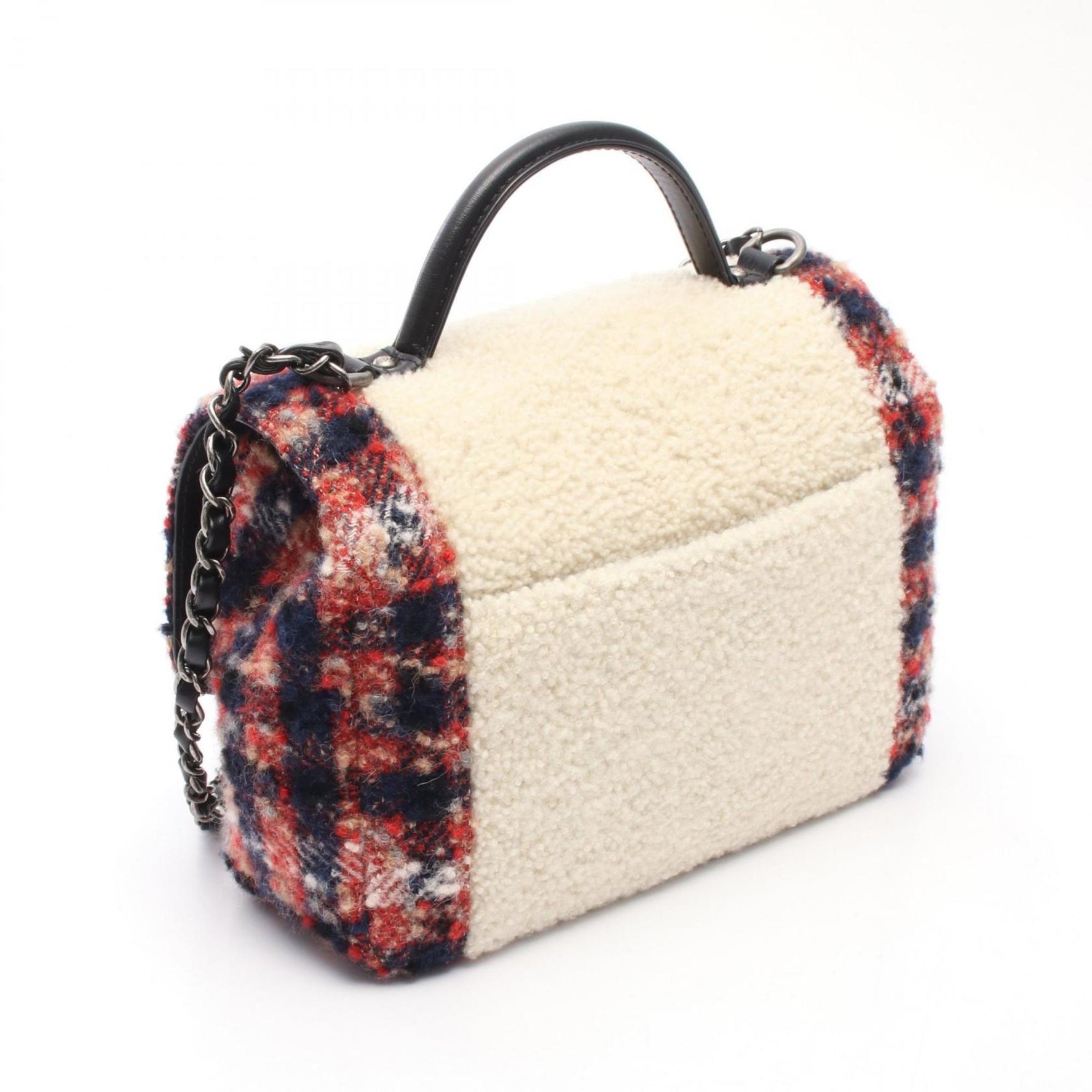 CHANEL top handle shoulder bag made of shearling, wool, and leather. Available in red, beige, multicolor.