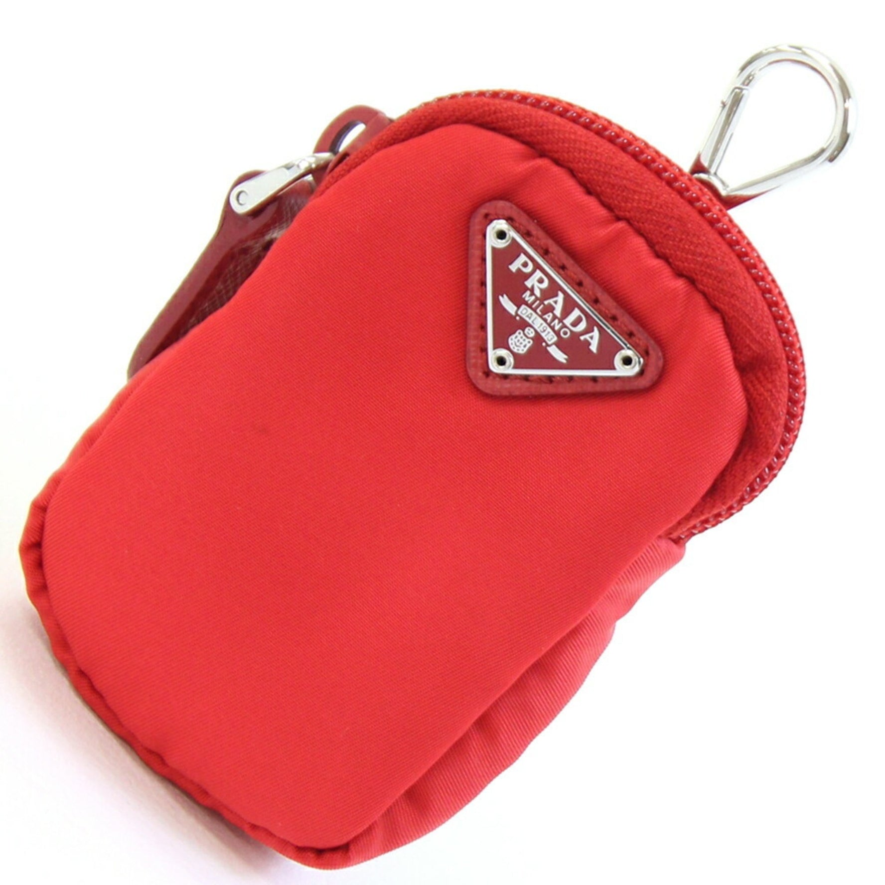 Prada red nylon and leather pouch with triangle bag charm .